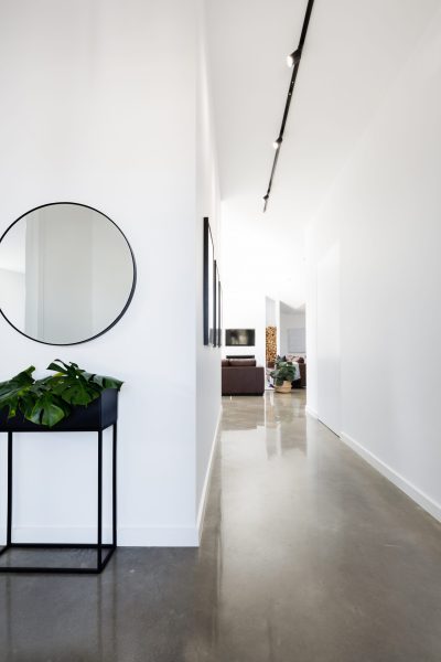 Contemporary new home entry and hallway with polished concrete floors